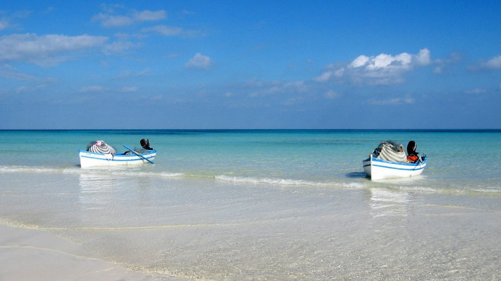 Two boats in a clear water sand beach