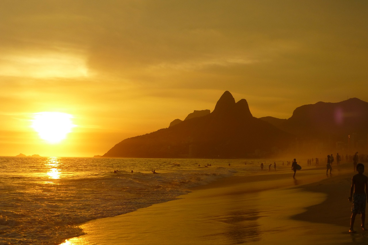 Beach, sunset and mountains in a yellow haze