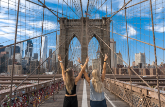 Two girls standing in New York city bridge