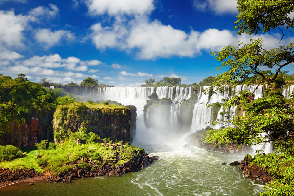 Iguazu Falls on a sunny day with greenery