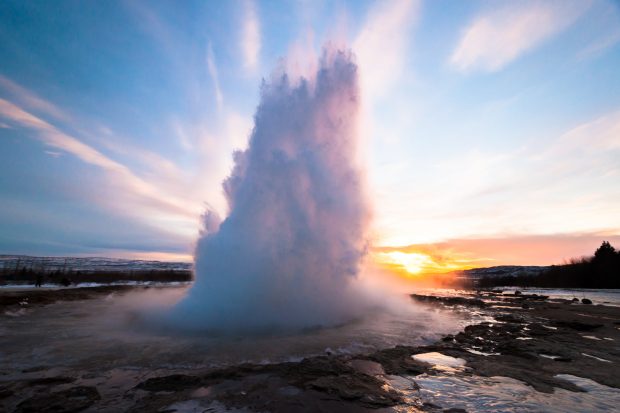 Geysir exploding in the sunset